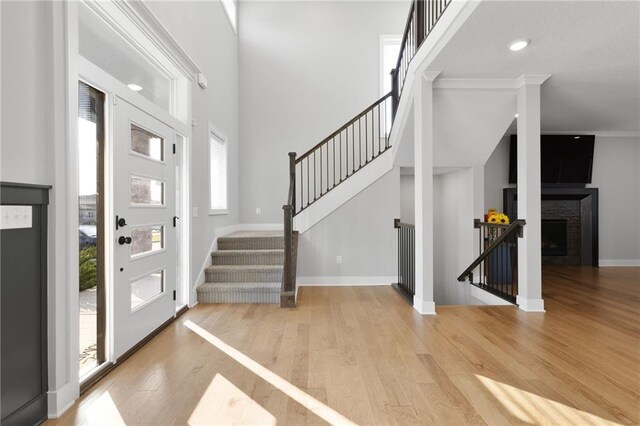 3113 SW Arboridge Dr, Lees Summit, MO 64081 - entryway with wood finished floors, stairway, and a fireplace