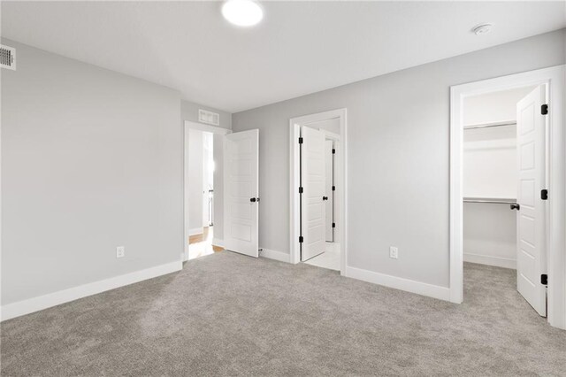 3113 SW Arboridge Dr, Lees Summit, MO 64081 - unfurnished bedroom featuring carpet flooring, a spacious closet, and a closet