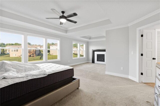 3113 SW Arboridge Dr, Lees Summit, MO 64081 - bedroom featuring crown molding, light colored carpet, a fireplace, a raised ceiling, and a ceiling fan