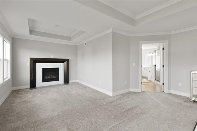 3113 SW Arboridge Dr, Lees Summit, MO 64081 - unfurnished living room featuring a tray ceiling, ornamental molding, light colored carpet, and a fireplace with flush hearth