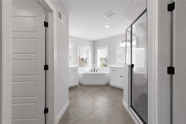 3113 SW Arboridge Dr, Lees Summit, MO 64081 - full bathroom featuring vanity, a shower stall, a freestanding bath, and tile patterned flooring