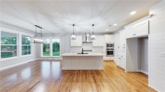 22902 S Ridgeview Dr, Peculiar, MO 64078 - kitchen featuring appliances with stainless steel finishes, wall chimney range hood, light countertops, backsplash, and white cabinets
