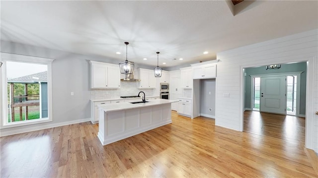 22902 S Ridgeview Dr, Peculiar, MO 64078 - kitchen with wall chimney range hood, stainless steel appliances, light countertops, white cabinets, and recessed lighting