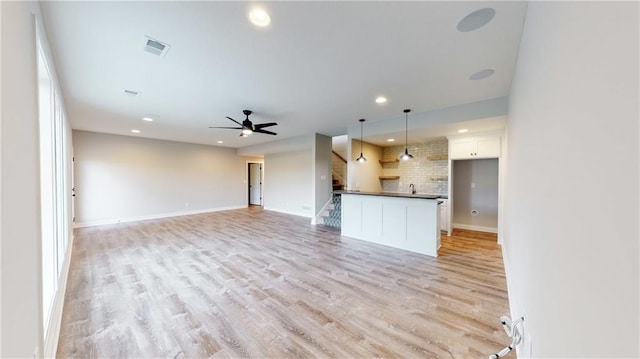 22902 S Ridgeview Dr, Peculiar, MO 64078 - unfurnished living room featuring recessed lighting, light wood-style floors, a ceiling fan, and stairway