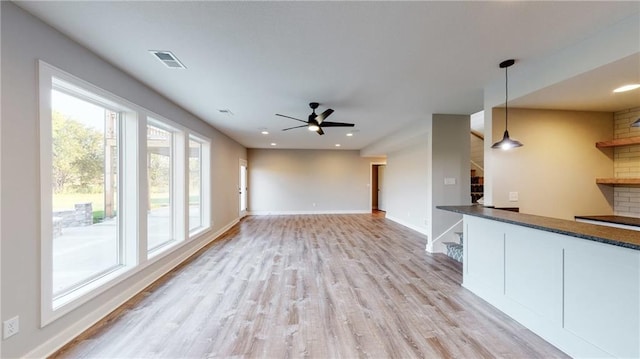 22902 S Ridgeview Dr, Peculiar, MO 64078 - unfurnished living room with light wood-type flooring, a ceiling fan, and recessed lighting