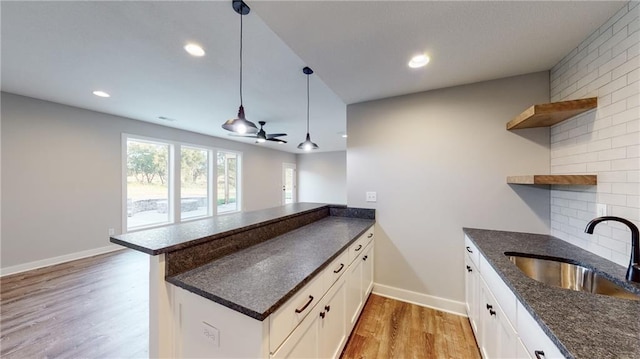 22902 S Ridgeview Dr, Peculiar, MO 64078 - kitchen featuring open shelves, light wood-style floors, a peninsula, white cabinetry, and ceiling fan