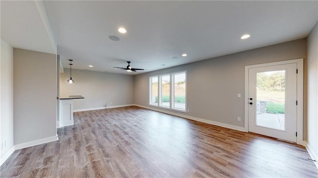 22902 S Ridgeview Dr, Peculiar, MO 64078 - unfurnished living room featuring a ceiling fan, light wood-style floors, and recessed lighting
