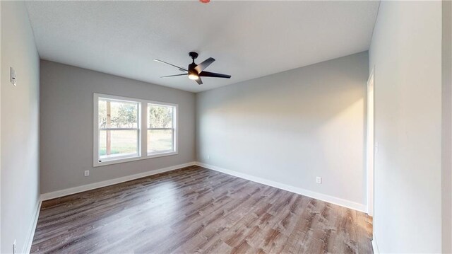 22902 S Ridgeview Dr, Peculiar, MO 64078 - spare room with wood finished floors and ceiling fan