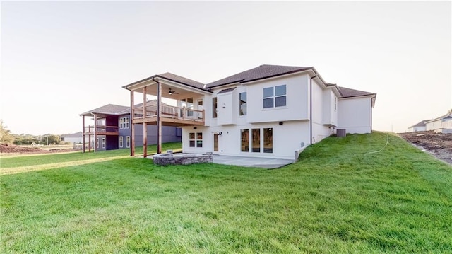 22902 S Ridgeview Dr, Peculiar, MO 64078 - back of house with a lawn, a ceiling fan, a patio area, a balcony, and stucco siding