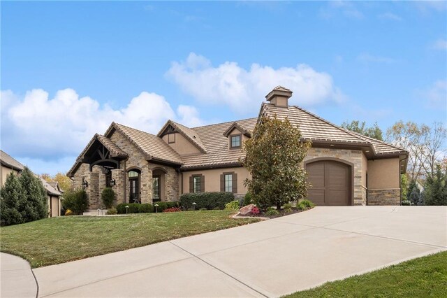 14713 Ash St, Leawood, KS 66224 - view of front facade with stone siding, a tiled roof, concrete driveway, a front yard, and stucco siding