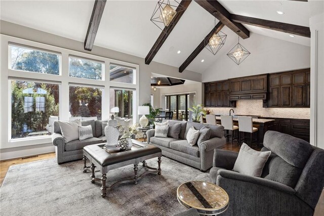 14713 Ash St, Leawood, KS 66224 - living area with high vaulted ceiling, beamed ceiling, light wood finished floors, and a chandelier