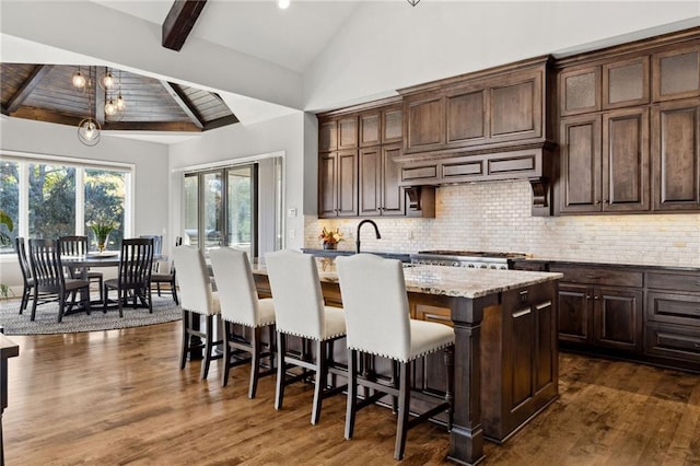 14713 Ash St, Leawood, KS 66224 - kitchen with backsplash, an island with sink, and dark wood-type flooring