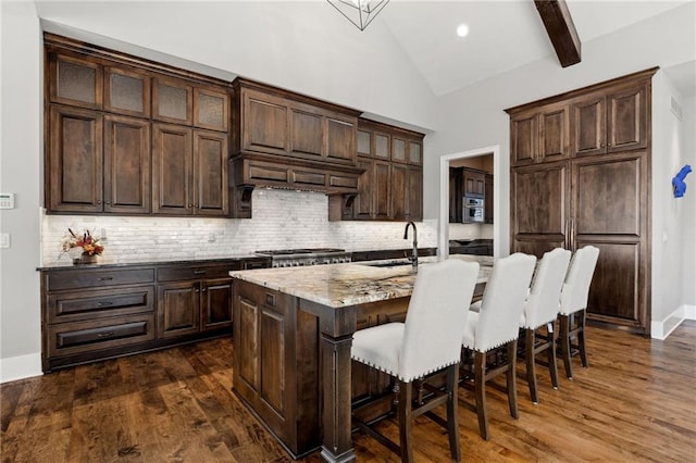 14713 Ash St, Leawood, KS 66224 - kitchen featuring a kitchen breakfast bar, backsplash, dark brown cabinetry, and high vaulted ceiling