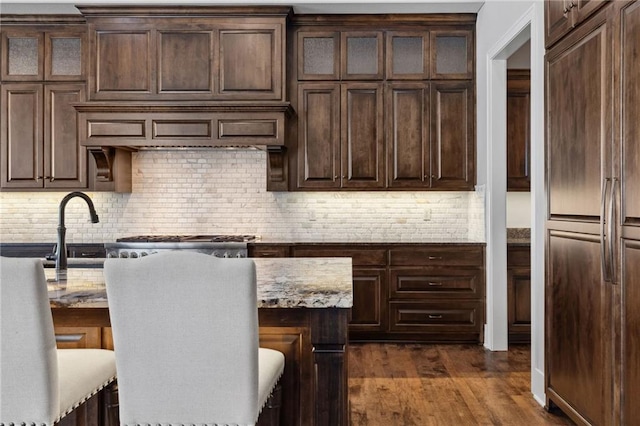 14713 Ash St, Leawood, KS 66224 - kitchen featuring decorative backsplash, dark wood-style flooring, and dark brown cabinetry