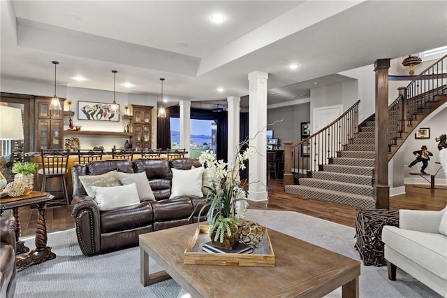 14713 Ash St, Leawood, KS 66224 - living area featuring decorative columns, recessed lighting, stairway, and wood finished floors