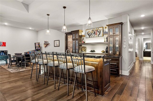14713 Ash St, Leawood, KS 66224 - indoor wet bar featuring dark wood-type flooring, hanging light fixtures, and recessed lighting