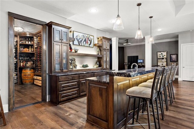 14713 Ash St, Leawood, KS 66224 - indoor bar with dark wood-style floors, recessed lighting, decorative light fixtures, and ornate columns