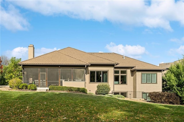 14713 Ash St, Leawood, KS 66224 - rear view of property with a chimney, a sunroom, a lawn, and stucco siding