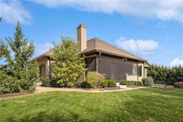 14713 Ash St, Leawood, KS 66224 - back of property featuring a chimney and a sunroom