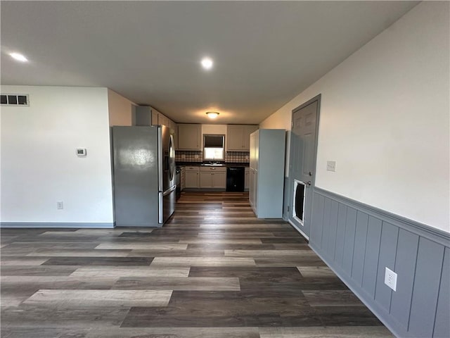 1915 W 5th St, Sedalia, MO 65301 - kitchen featuring stainless steel fridge with ice dispenser, dark countertops, dark wood-style floors, a wainscoted wall, and decorative backsplash