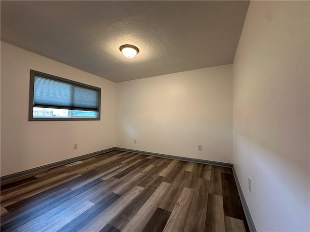 1915 W 5th St, Sedalia, MO 65301 - unfurnished room featuring dark wood finished floors and a textured ceiling