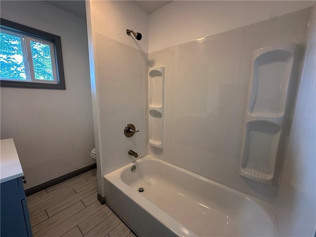 1915 W 5th St, Sedalia, MO 65301 - bathroom featuring vanity, wood finish floors, and bathtub / shower combination