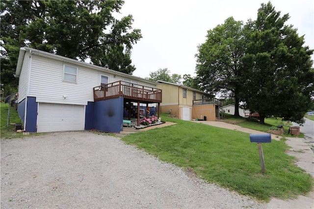 1429 S 6th St, Atchison, KS 66002 - ranch-style house featuring a wooden deck, a garage, a front lawn, and gravel driveway