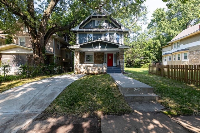 3428 College Ave, Kansas City, MO 64128 - view of front of house featuring stone siding and covered porch