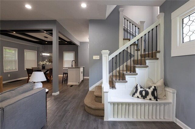 3428 College Ave, Kansas City, MO 64128 - stairs featuring wood finished floors, recessed lighting, beam ceiling, and coffered ceiling