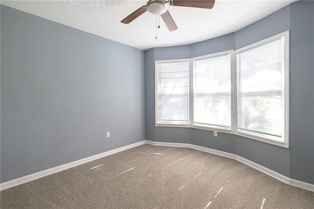 3428 College Ave, Kansas City, MO 64128 - carpeted spare room featuring ceiling fan and baseboards