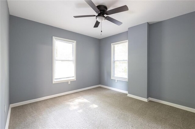 3428 College Ave, Kansas City, MO 64128 - empty room with carpet and a ceiling fan
