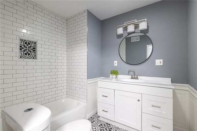 3428 College Ave, Kansas City, MO 64128 - bathroom featuring vanity and shower / washtub combination
