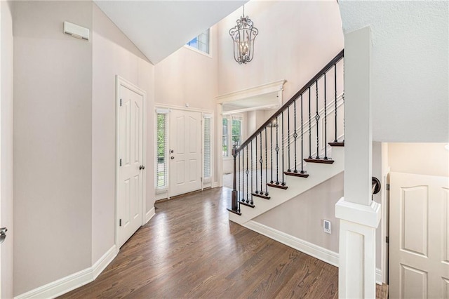 4824 W 162nd St, Overland Park, KS 66085 - foyer with wood finished floors, stairs, high vaulted ceiling, and a chandelier
