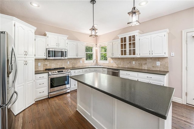 4824 W 162nd St, Overland Park, KS 66085 - kitchen with appliances with stainless steel finishes, dark countertops, white cabinetry, dark wood-style floors, and recessed lighting