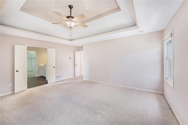 4824 W 162nd St, Overland Park, KS 66085 - unfurnished bedroom featuring a raised ceiling, carpet, ensuite bathroom, and a ceiling fan