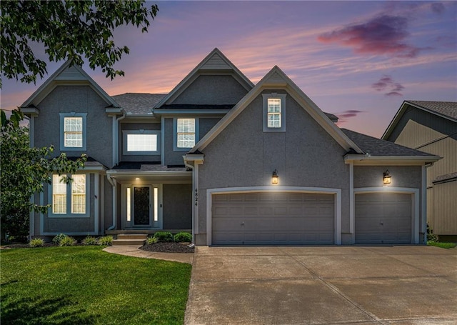4824 W 162nd St, Overland Park, KS 66085 - view of front of house with concrete driveway, a yard, stucco siding, and an attached garage