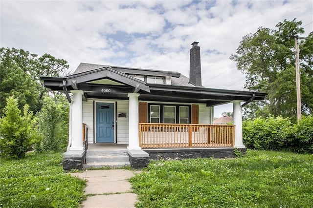 4600 Chestnut Ave, Kansas City, MO 64130 - view of front of house with a porch and a chimney