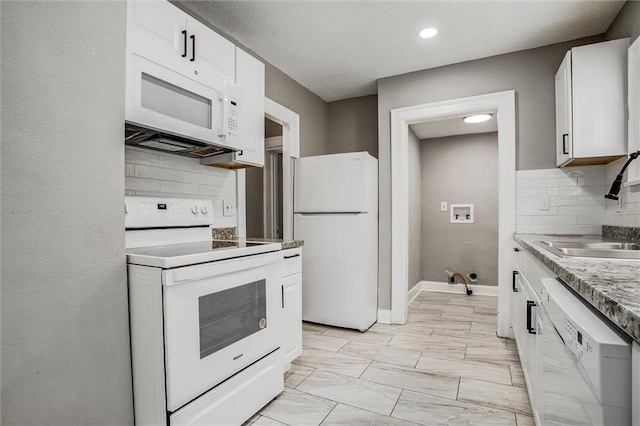 4600 Chestnut Ave, Kansas City, MO 64130 - kitchen with white appliances, decorative backsplash, white cabinets, light countertops, and recessed lighting