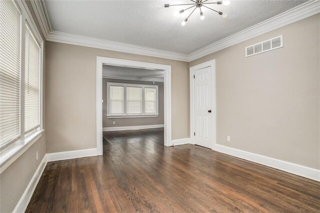 4600 Chestnut Ave, Kansas City, MO 64130 - unfurnished room with a chandelier, a textured ceiling, dark wood finished floors, and crown molding