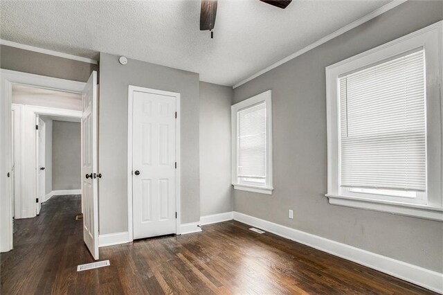 4600 Chestnut Ave, Kansas City, MO 64130 - unfurnished bedroom with dark wood-style flooring, ornamental molding, and ceiling fan