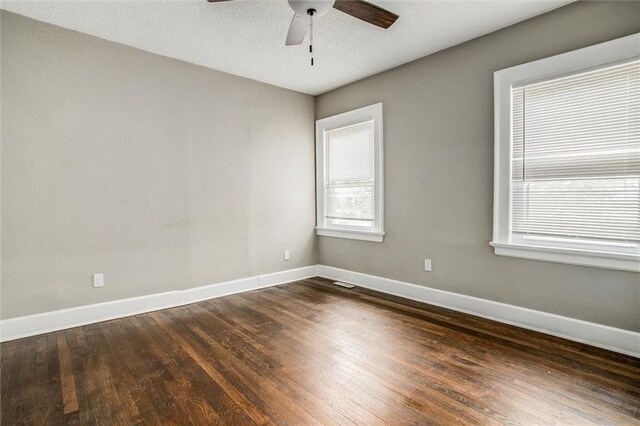 4600 Chestnut Ave, Kansas City, MO 64130 - unfurnished room with plenty of natural light, ceiling fan, and dark wood finished floors