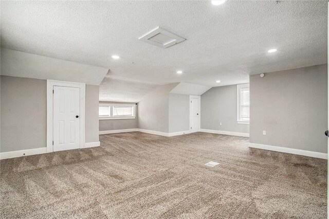 4600 Chestnut Ave, Kansas City, MO 64130 - additional living space with a textured ceiling, carpet flooring, recessed lighting, and lofted ceiling