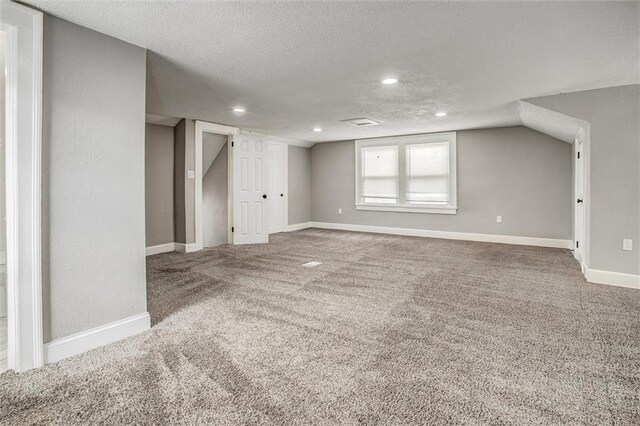 4600 Chestnut Ave, Kansas City, MO 64130 - below grade area featuring a textured ceiling, carpet floors, and recessed lighting
