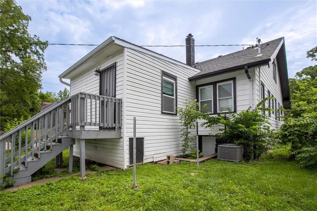 4600 Chestnut Ave, Kansas City, MO 64130 - view of property exterior with a chimney and a lawn