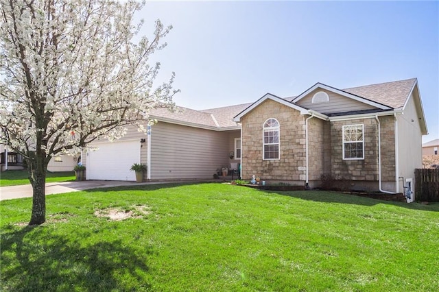 2180 Rock Creek Dr, Tonganoxie, KS 66086 - single story home featuring stone siding, a garage, concrete driveway, and a front lawn