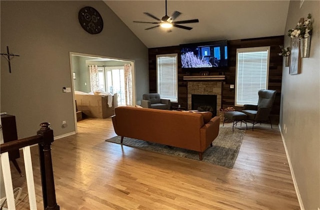 2180 Rock Creek Dr, Tonganoxie, KS 66086 - living area featuring ceiling fan, wood finished floors, a fireplace, and high vaulted ceiling