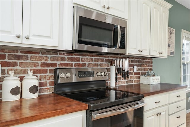 2180 Rock Creek Dr, Tonganoxie, KS 66086 - kitchen with stainless steel appliances, butcher block counters, backsplash, and white cabinets