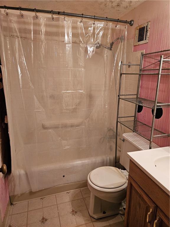 1419 W College Ter, Independence, MO 64050 - bathroom with shower / bathtub combination with curtain, vanity, and tile patterned flooring