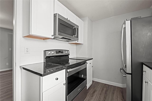 520 Sandusky Ave, Kansas City, KS 66101 - kitchen featuring stainless steel appliances, dark wood-type flooring, decorative backsplash, white cabinets, and a textured ceiling