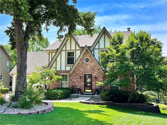 4117 NE Edgewater Ct, Lees Summit, MO 64064 - tudor home with stucco siding, a front lawn, brick siding, and a shingled roof